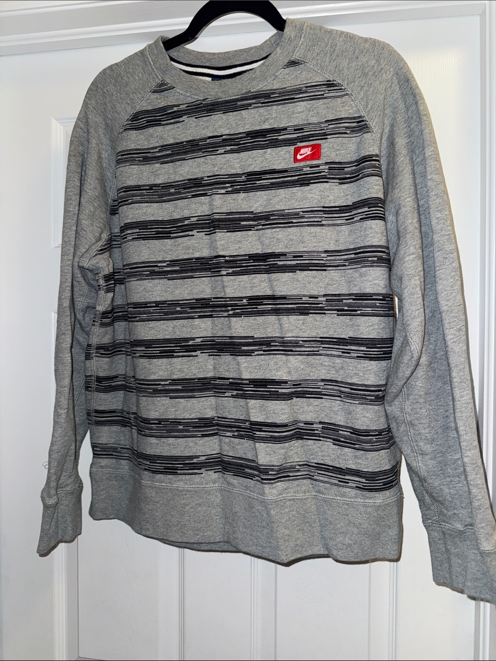Nike Gray Crewneck Sweatshirt with Black Stripe Pattern and Red Logo